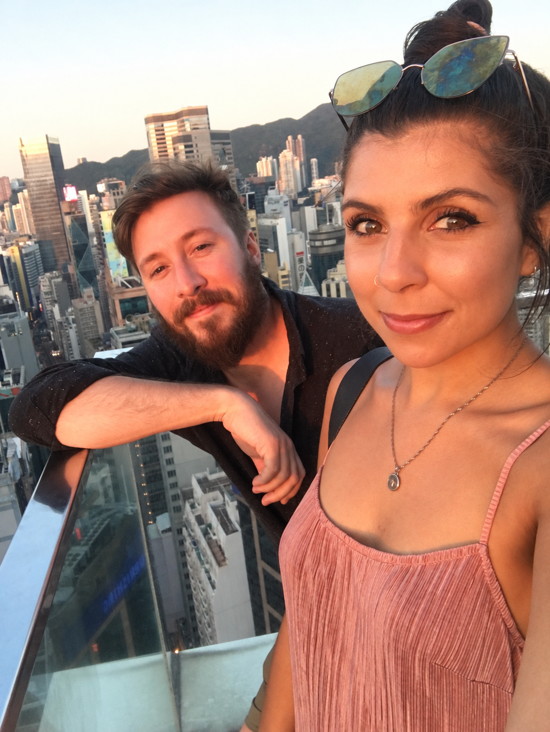 Nicole and Lawrence enjoying the sunset on a rooftop